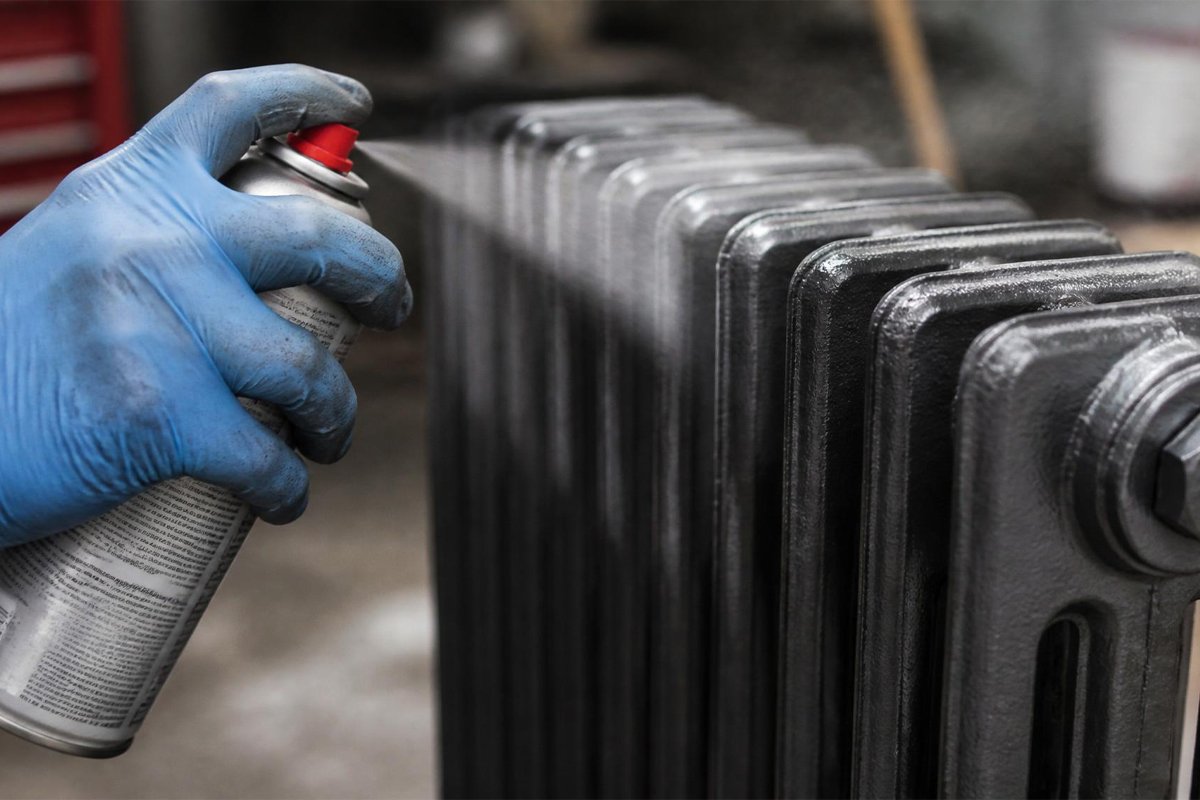 hand spray painting cast iron radiator fins closeup