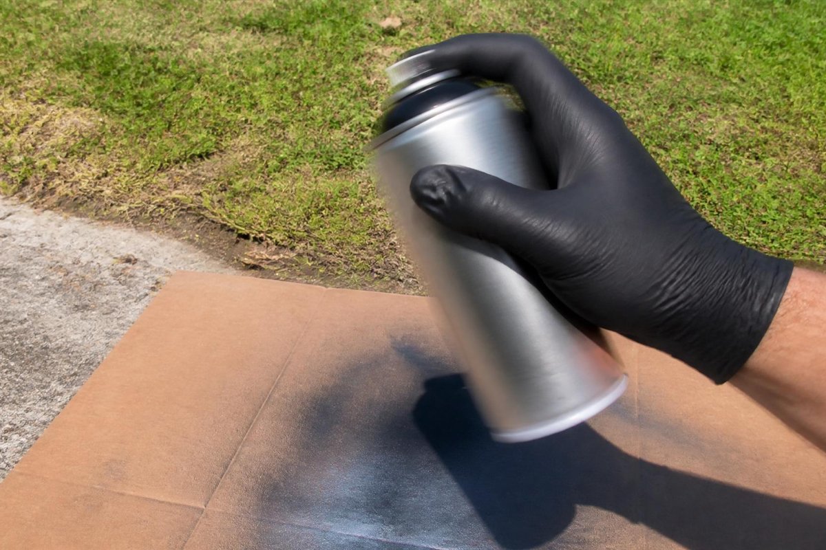 hand testing spray paint can for empty rattle test outdoors