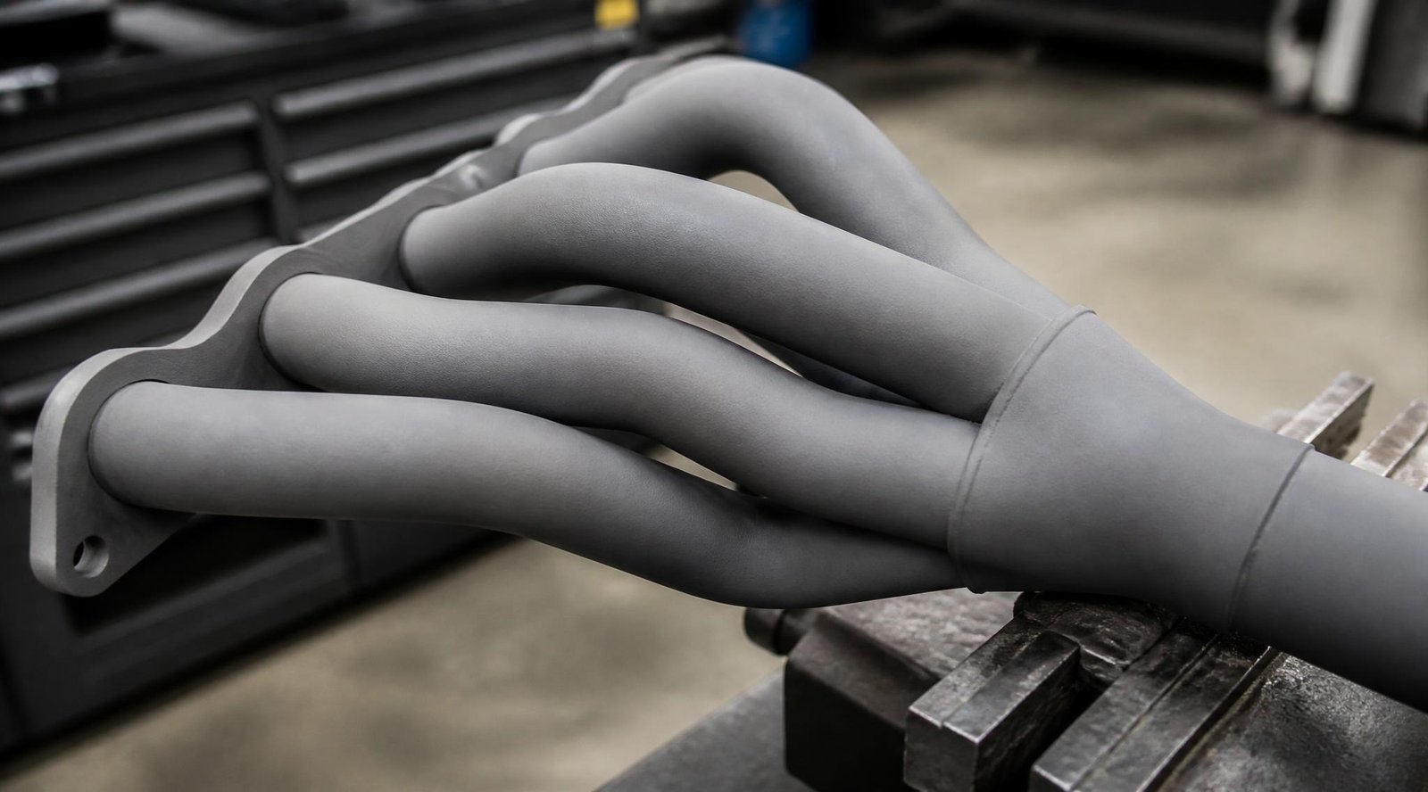 gpt image 2 Close up of a set of car exhaust headers coated in an even matte ceramic gray fi 0