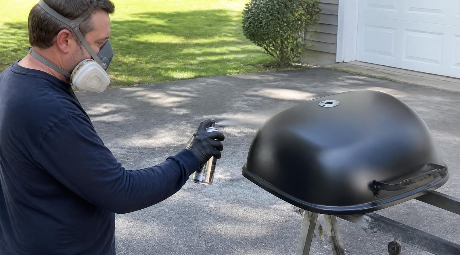 gpt image 2 Side view of a person in gloves and a respirator spraying a metal grill lid from 0